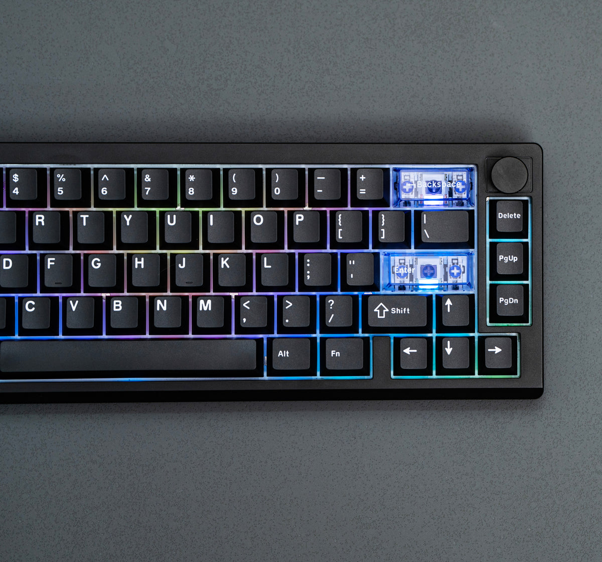 Close-up of the black EPOMAKER Magcore65 Lite 65% inductive analogue gaming keyboard with RGB-lit navigation keys and knob