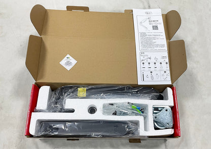 Open KALOC DS110 box with wrapped arm components, foam inserts, mounting hardware and instruction leaflet.